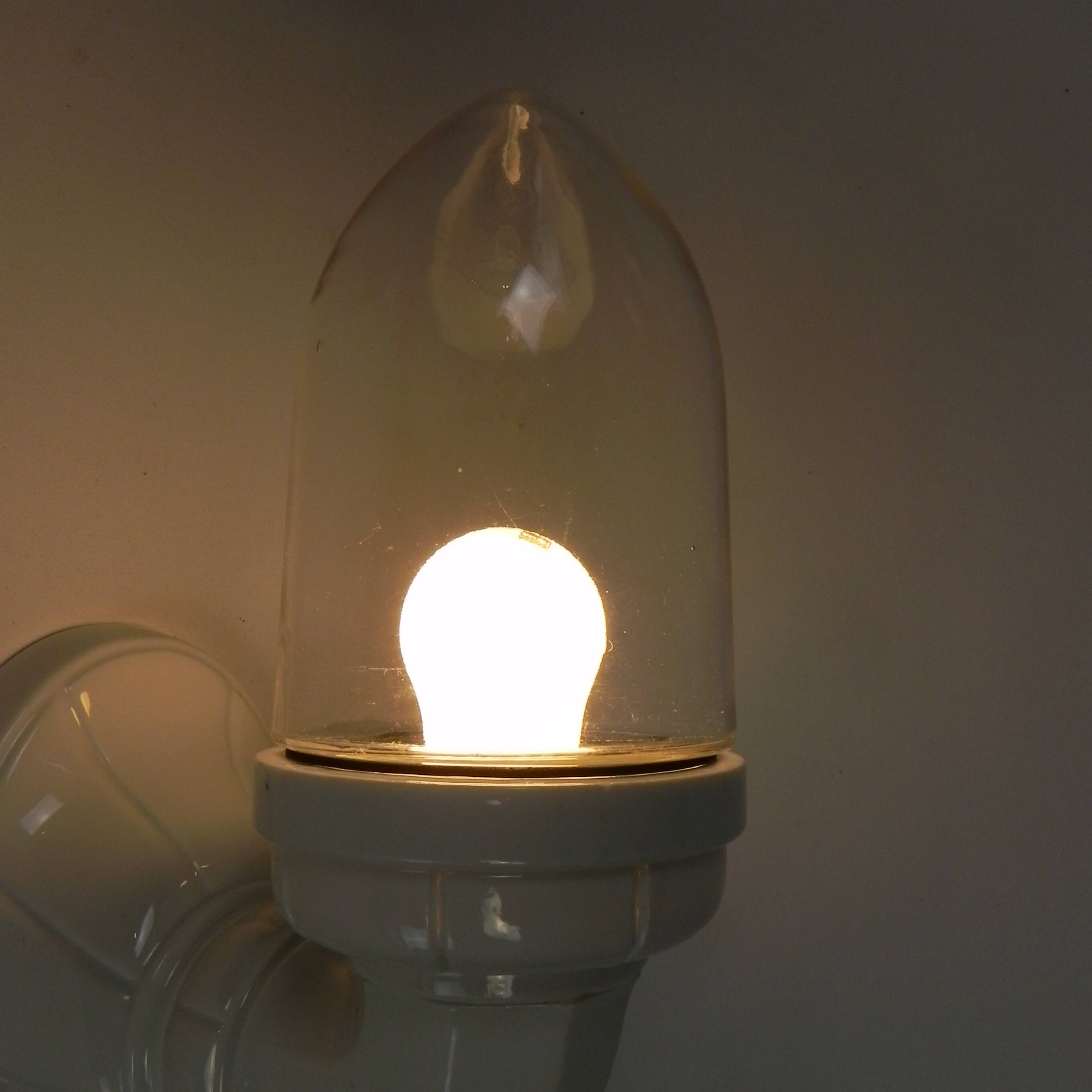Wall lamp in porcelain with a transparent glass shade, 1930s.