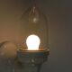 Wall lamp in porcelain with a transparent glass shade, 1930s.