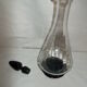 Dark purple glass wine carafe with a stopper.