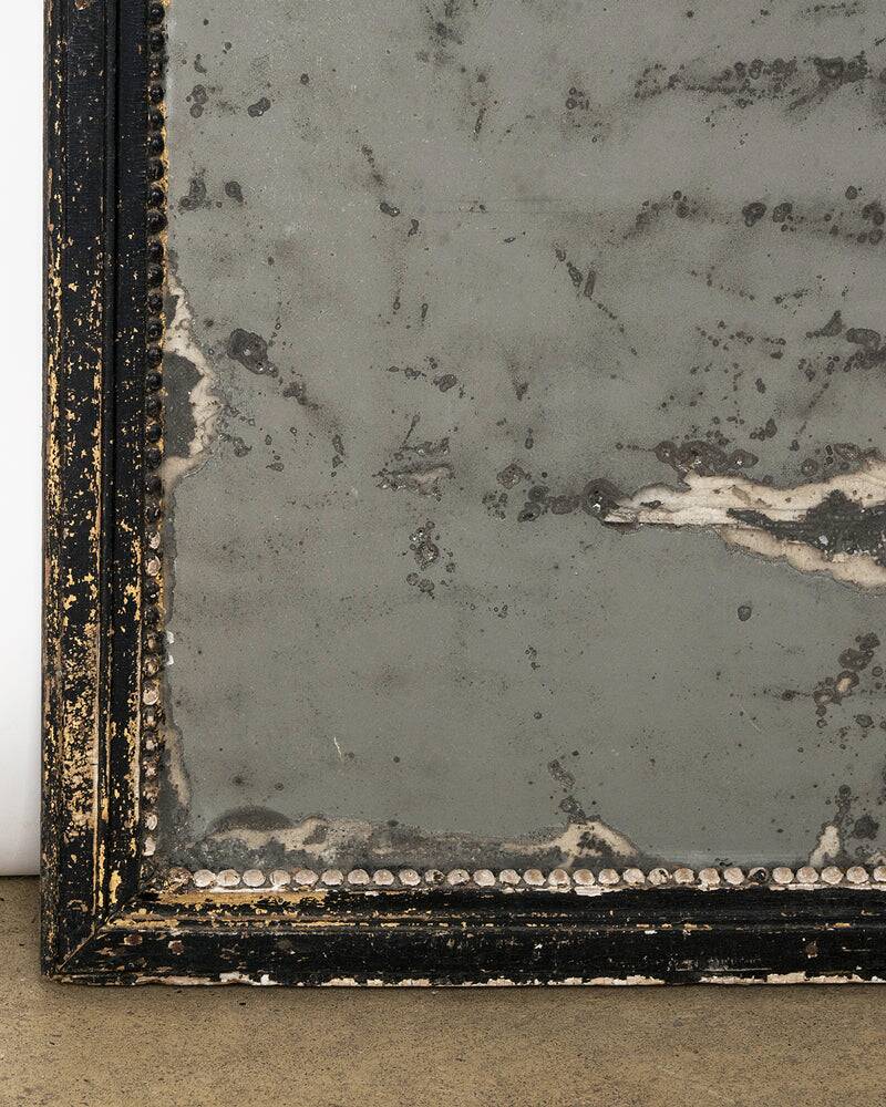 Antique French mirror from the late 19th century with a black painted frame.