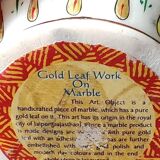 Hindu marble vase with floral decoration and gold leaf, in a box. Height 20 cm.