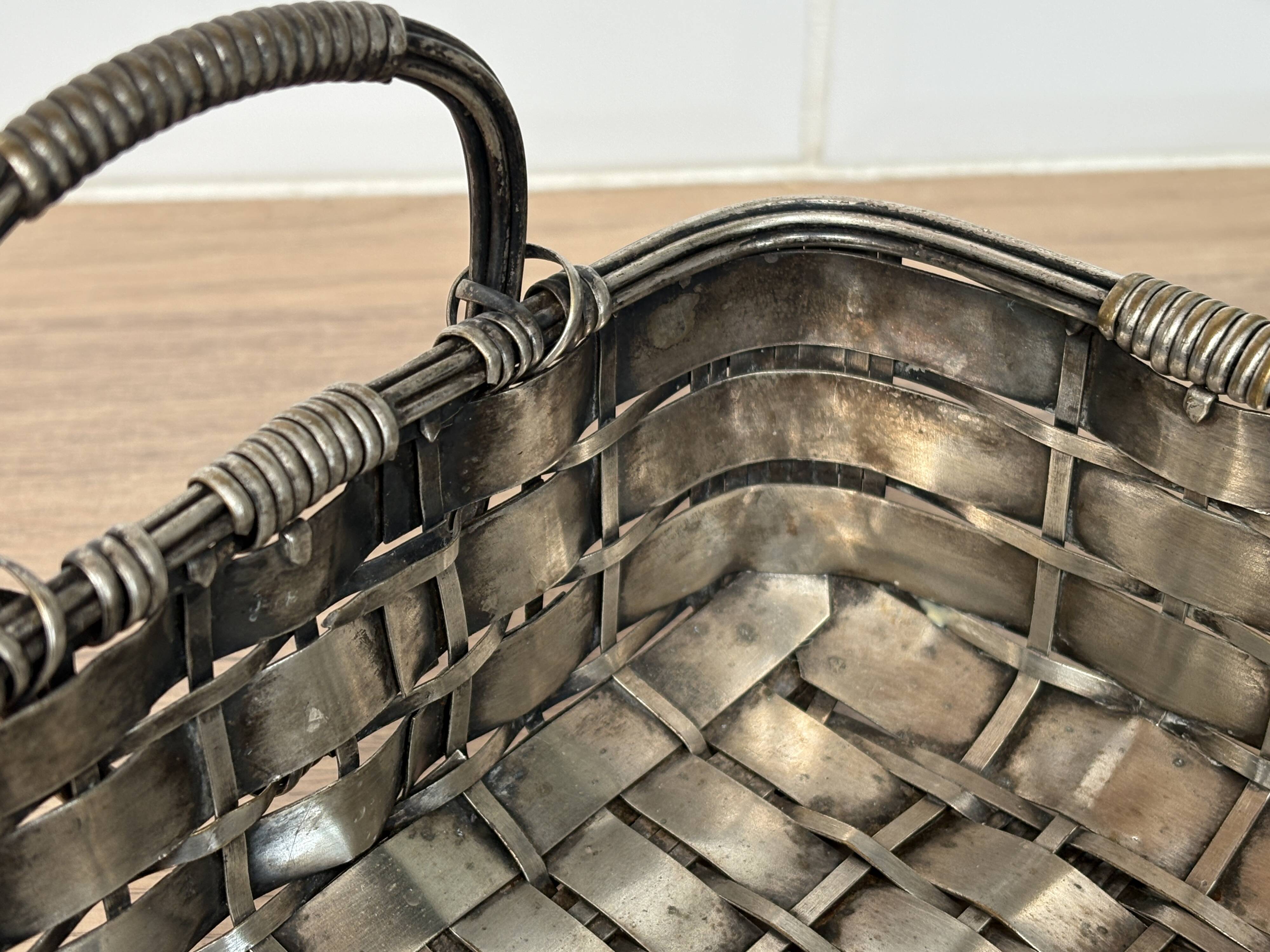 Woven silver-plated metal basket.