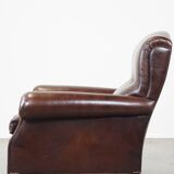 Comfortable and correct dark antique sheepskin English armchair in very good condition