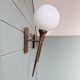 Pair of Art Deco wall sconces in brass and white opaline, 1930.