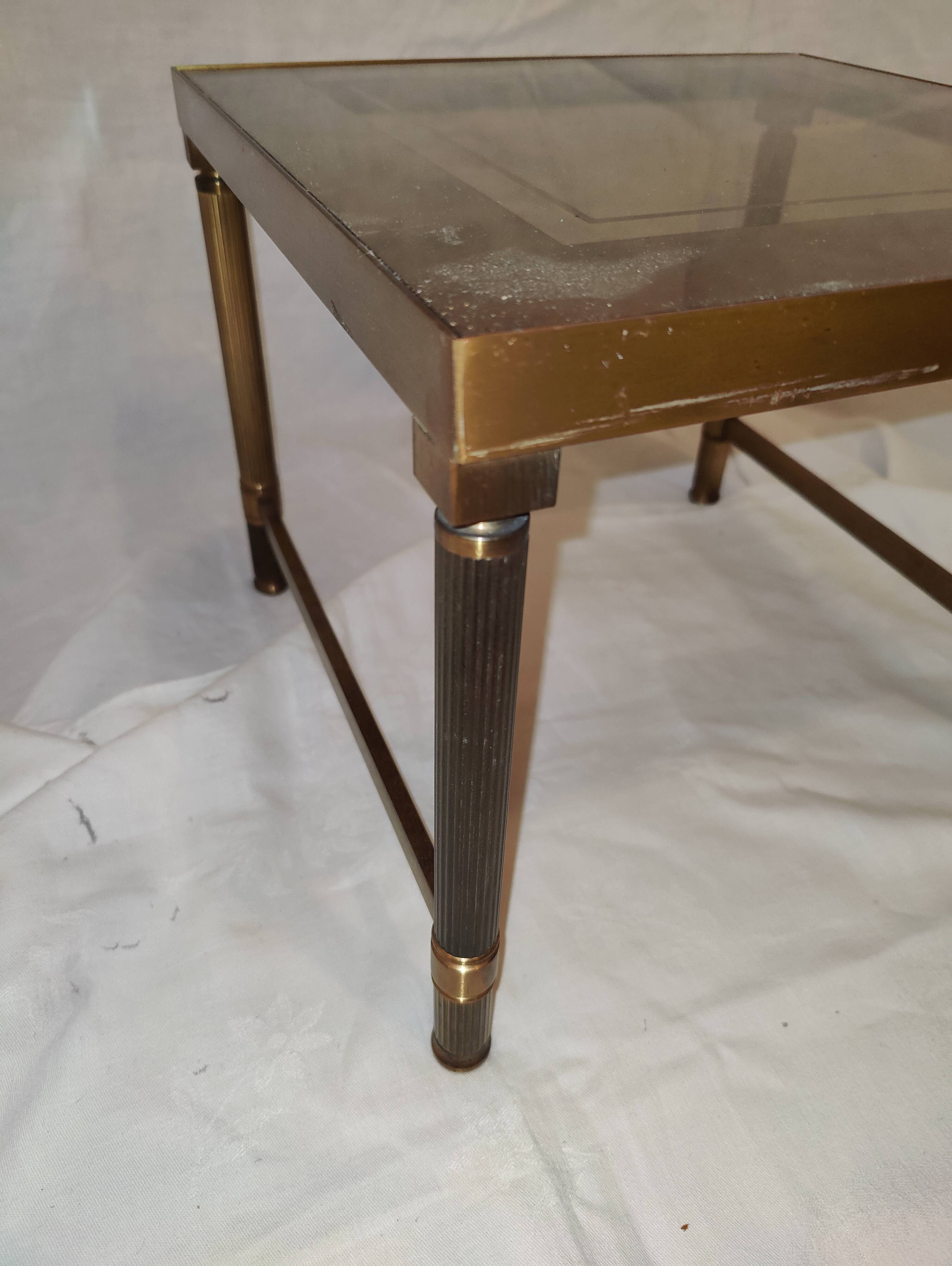 Small table or side table with brass structure and glass top from the 1970s.