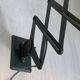 Vintage 1950s green lacquered sheet metal workshop wall light with accordion arm.