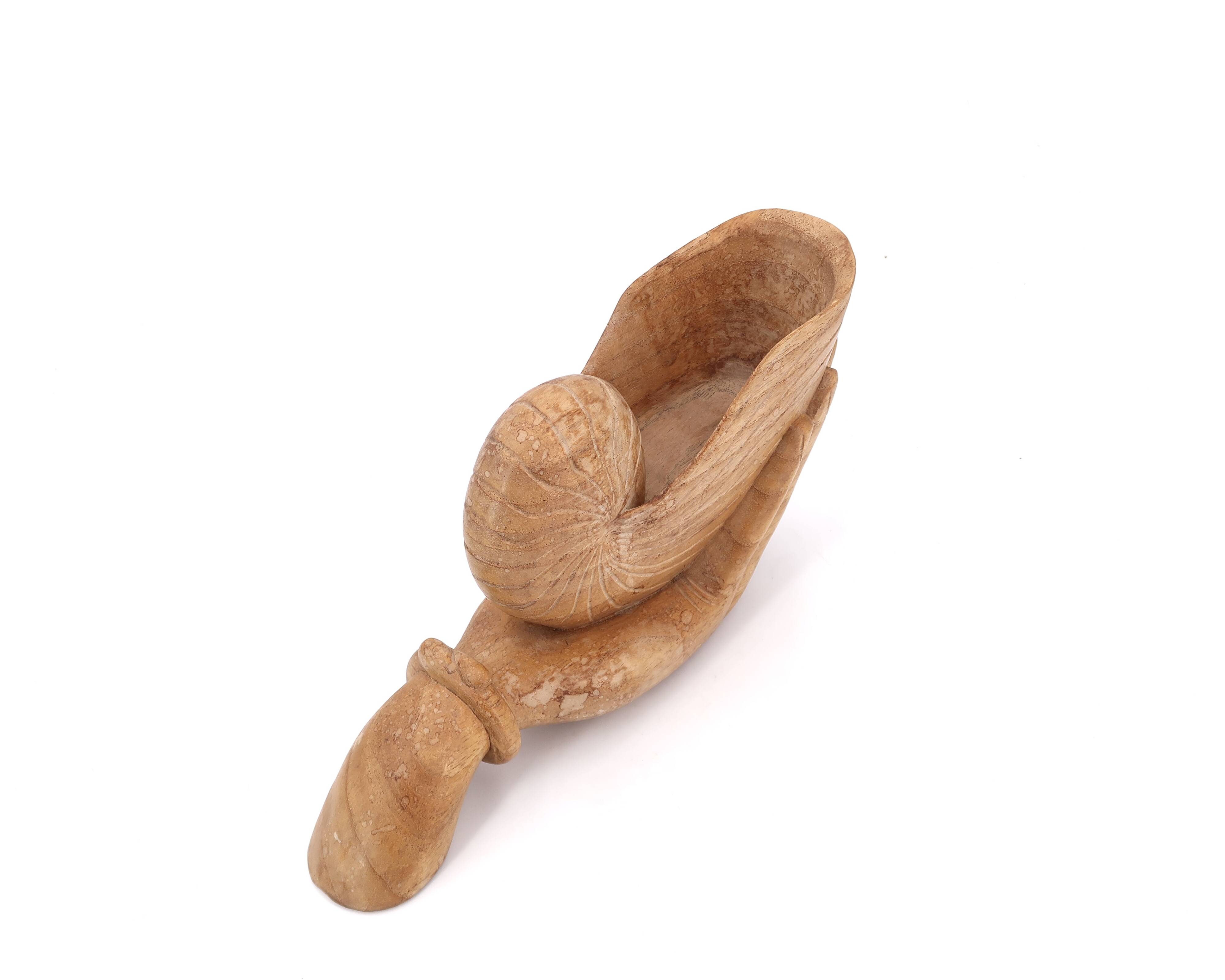 Wooden hand emptier holding a shell, 1970s