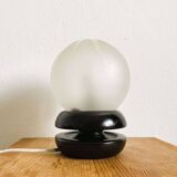 Small black wooden table lamp with frosted glass globe