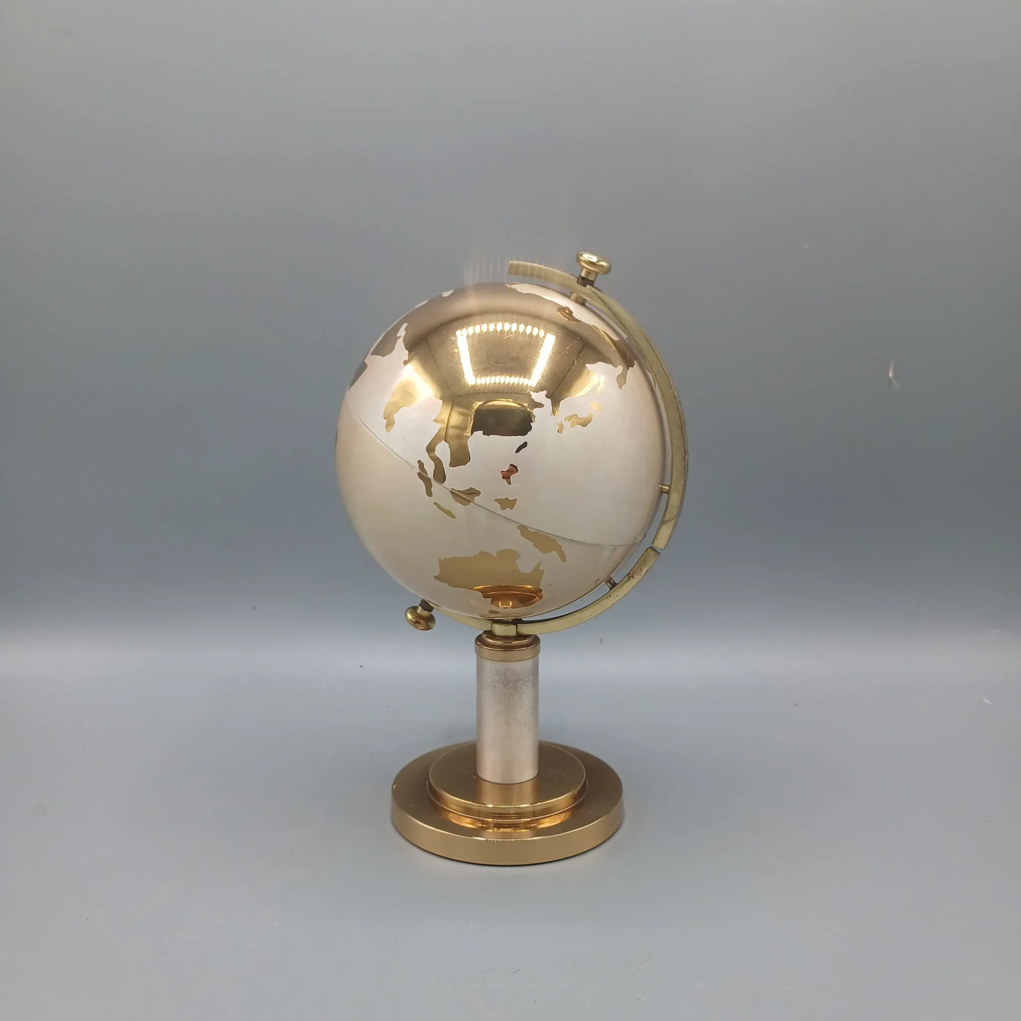 Vintage brass globe cigarette dispenser