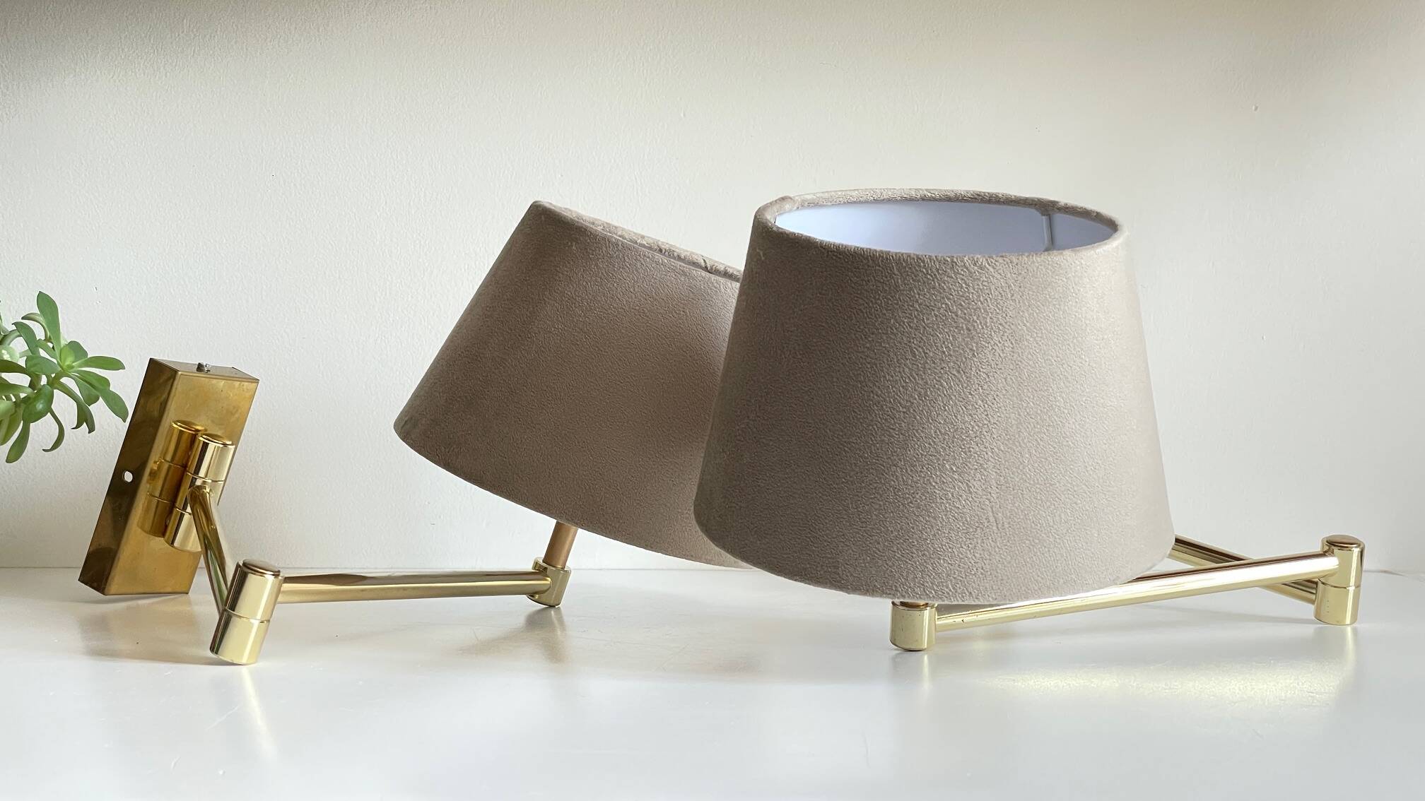 articulated brass and velvet wall light