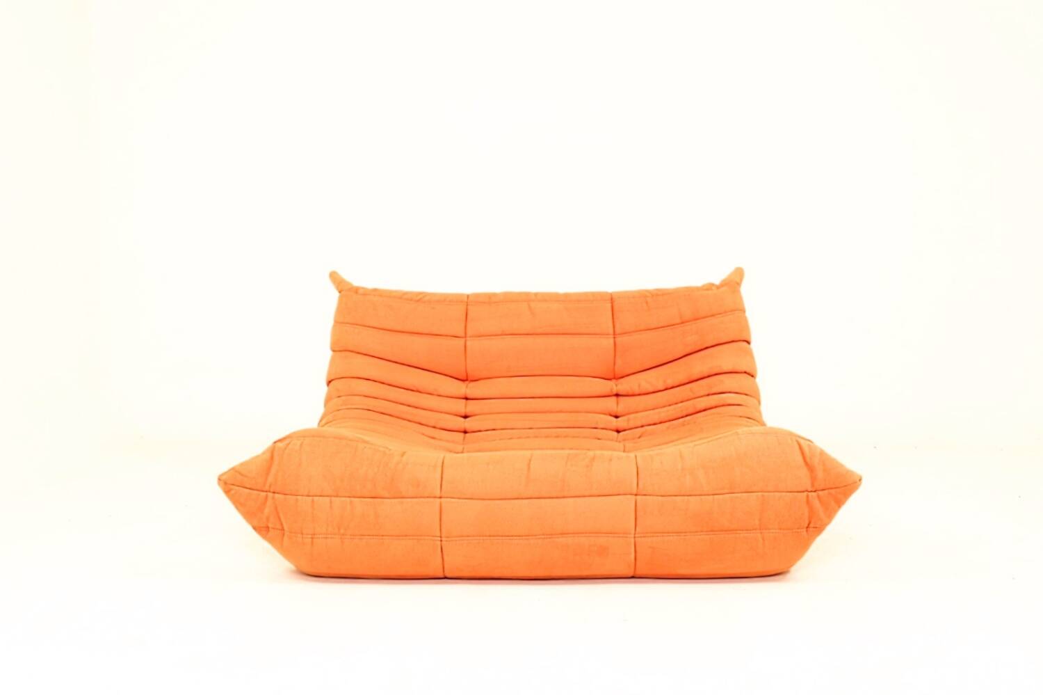 Togo sofa set and armchairs in pumpkin orange, 3 pieces, no label.