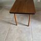 Mid-century coffee table with tapered legs.