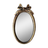 Old oval gilded stucco mirror