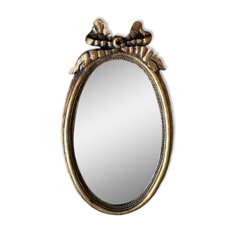 Old oval gilded stucco mirror