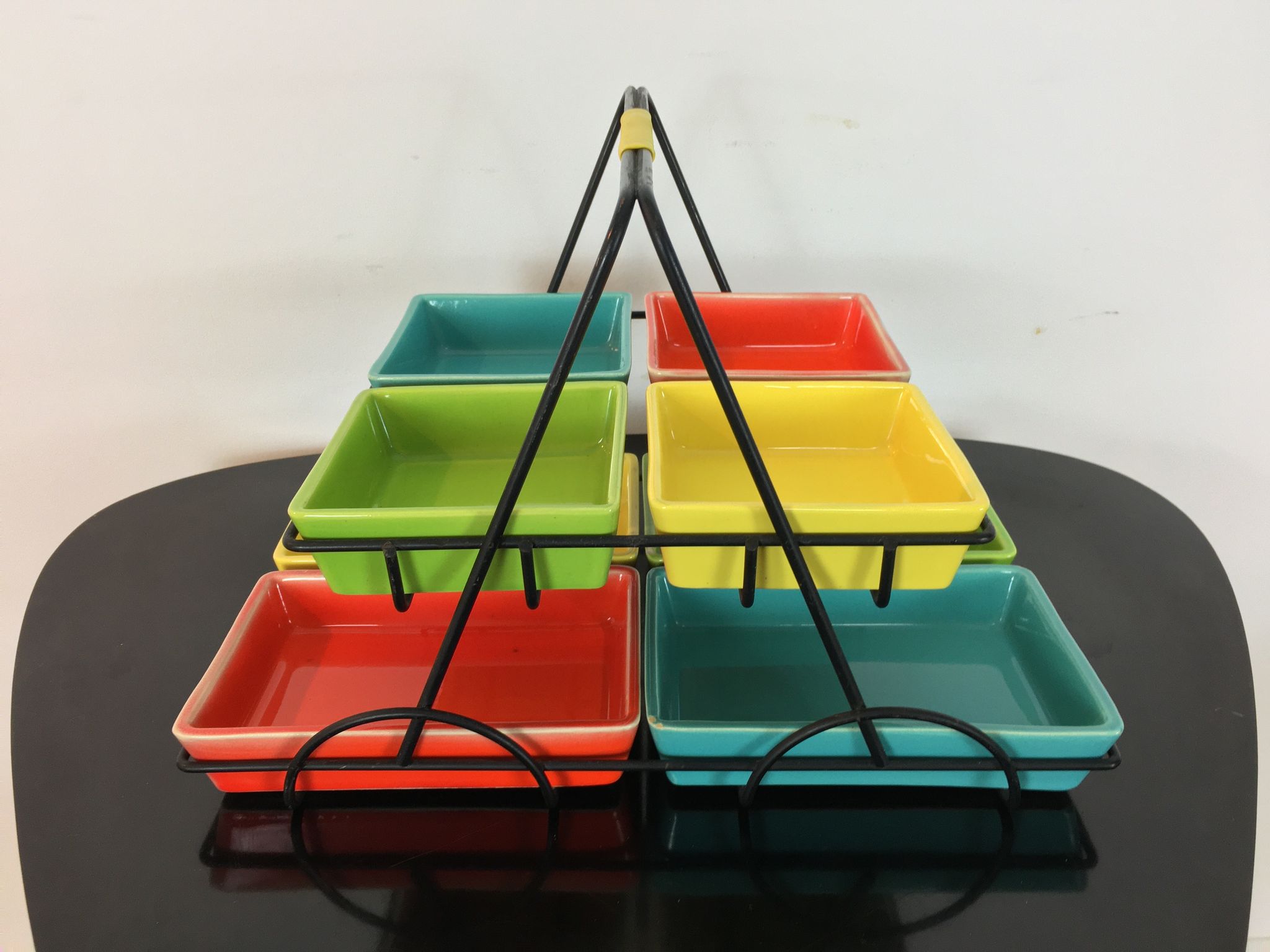 Black metal appetizer set with colorful ceramic ramekins