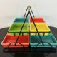 Black metal appetizer set with colorful ceramic ramekins