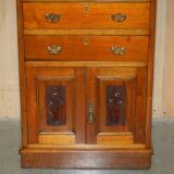 Victorian high chest of drawers in walnut with a bronze gallery.