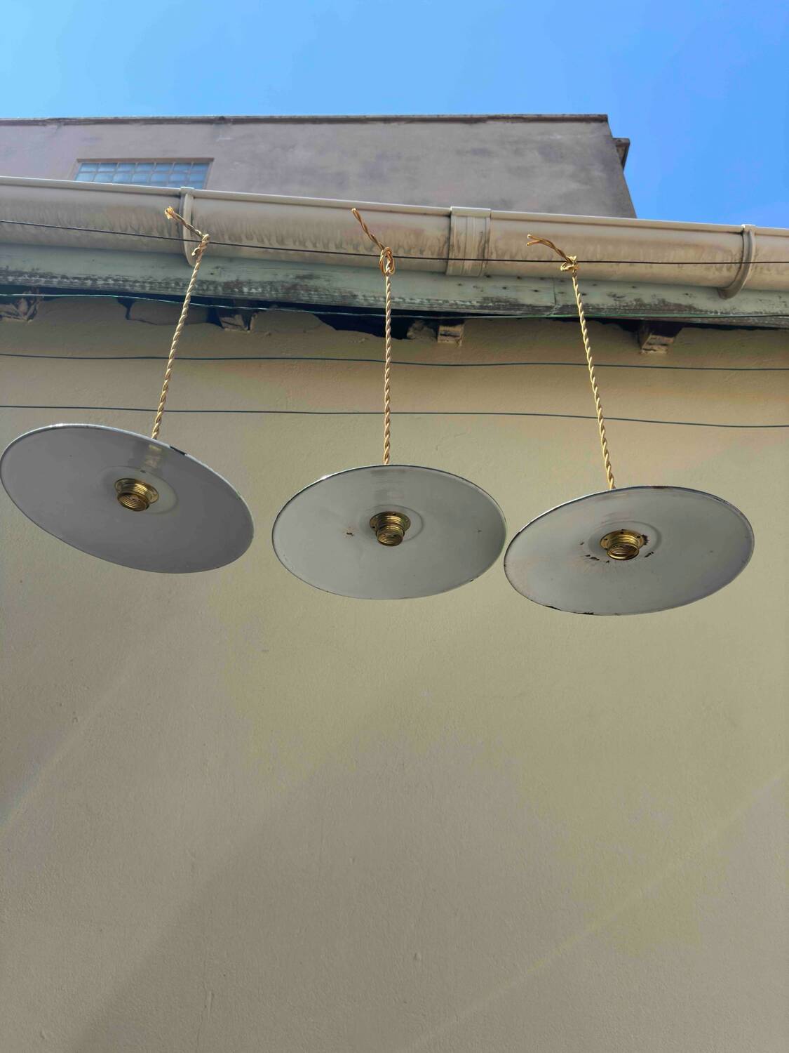 Trio of vintage pendant lampshades in enamelled sheet metal with gold threads