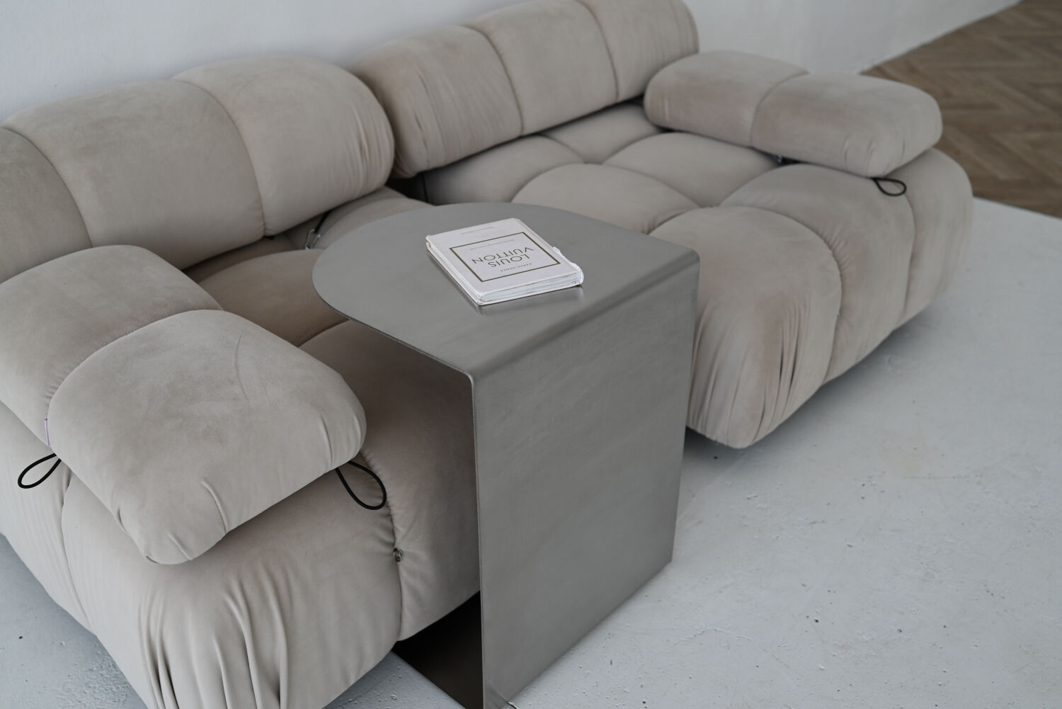 C-shaped brushed stainless steel side table