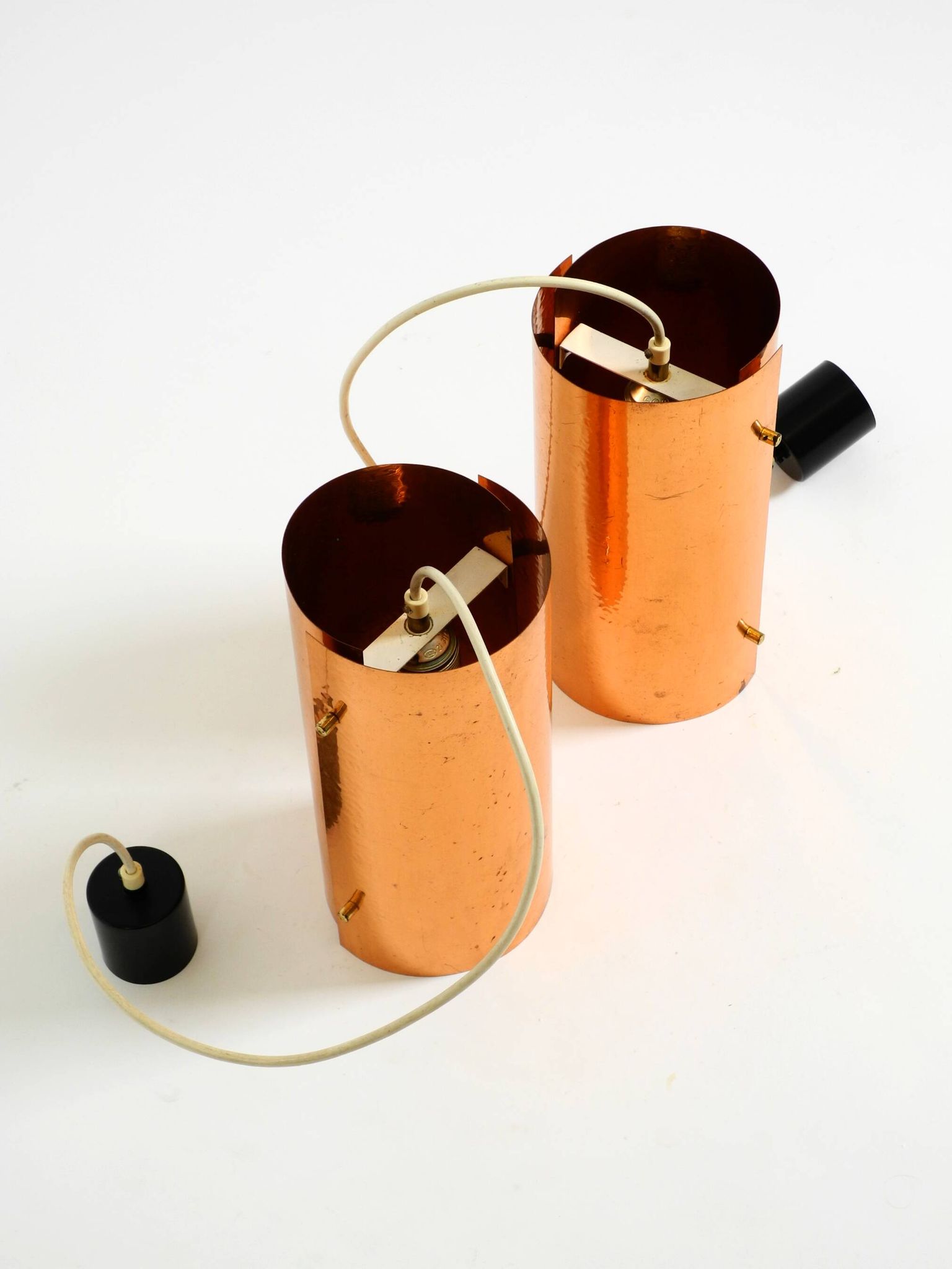 Two 50s tube pendant lamps consisting of two screwed-together copper bowls