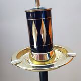 Vintage floor ashtray with a gold and black metal cigarette dispenser.