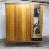 French wardrobe with tapered legs, 3 doors, 1 mirror (27*130), and 1 drawer.