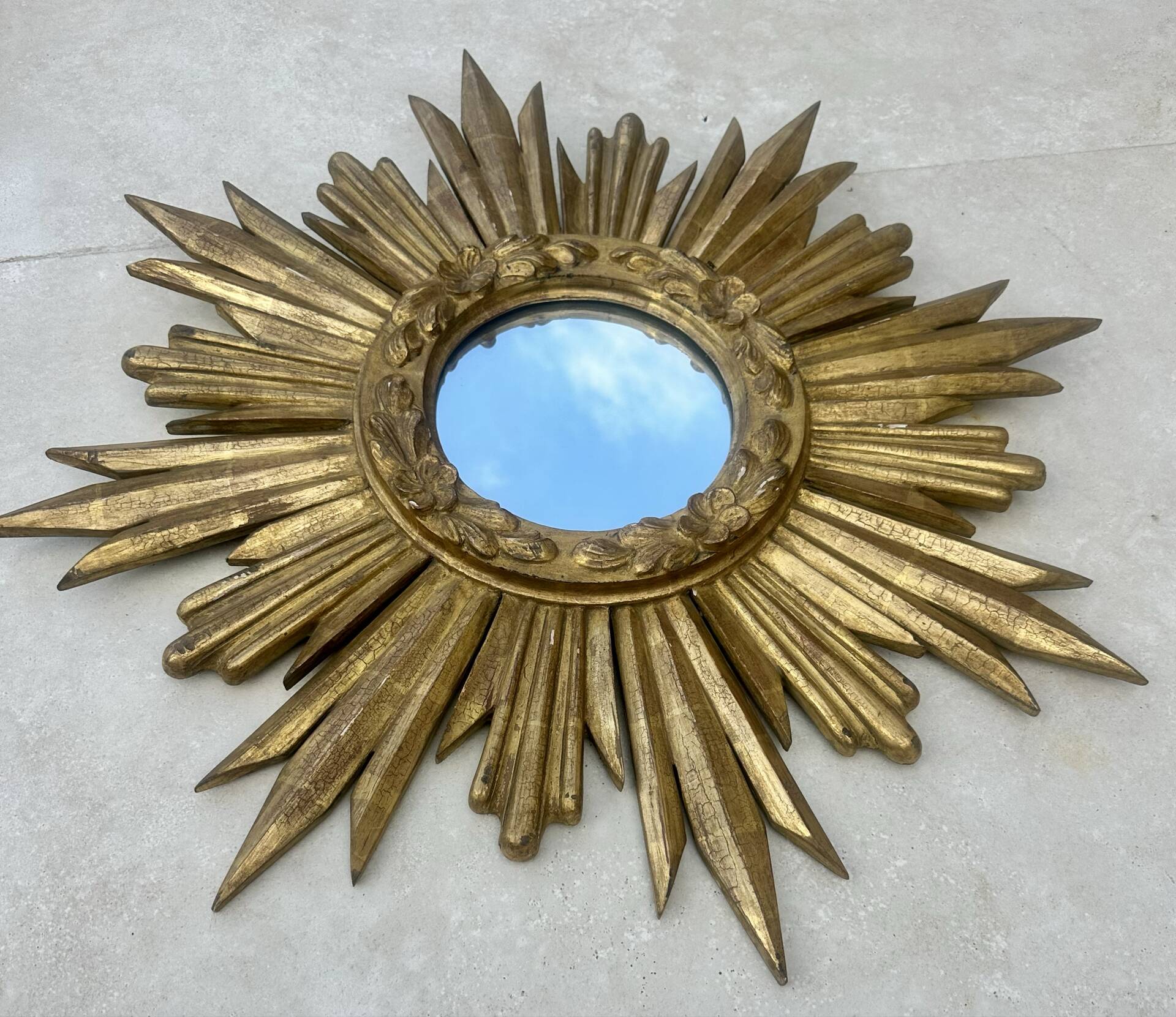 Large sun mirror in carved gilded wood.