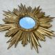 Large sun mirror in carved gilded wood.
