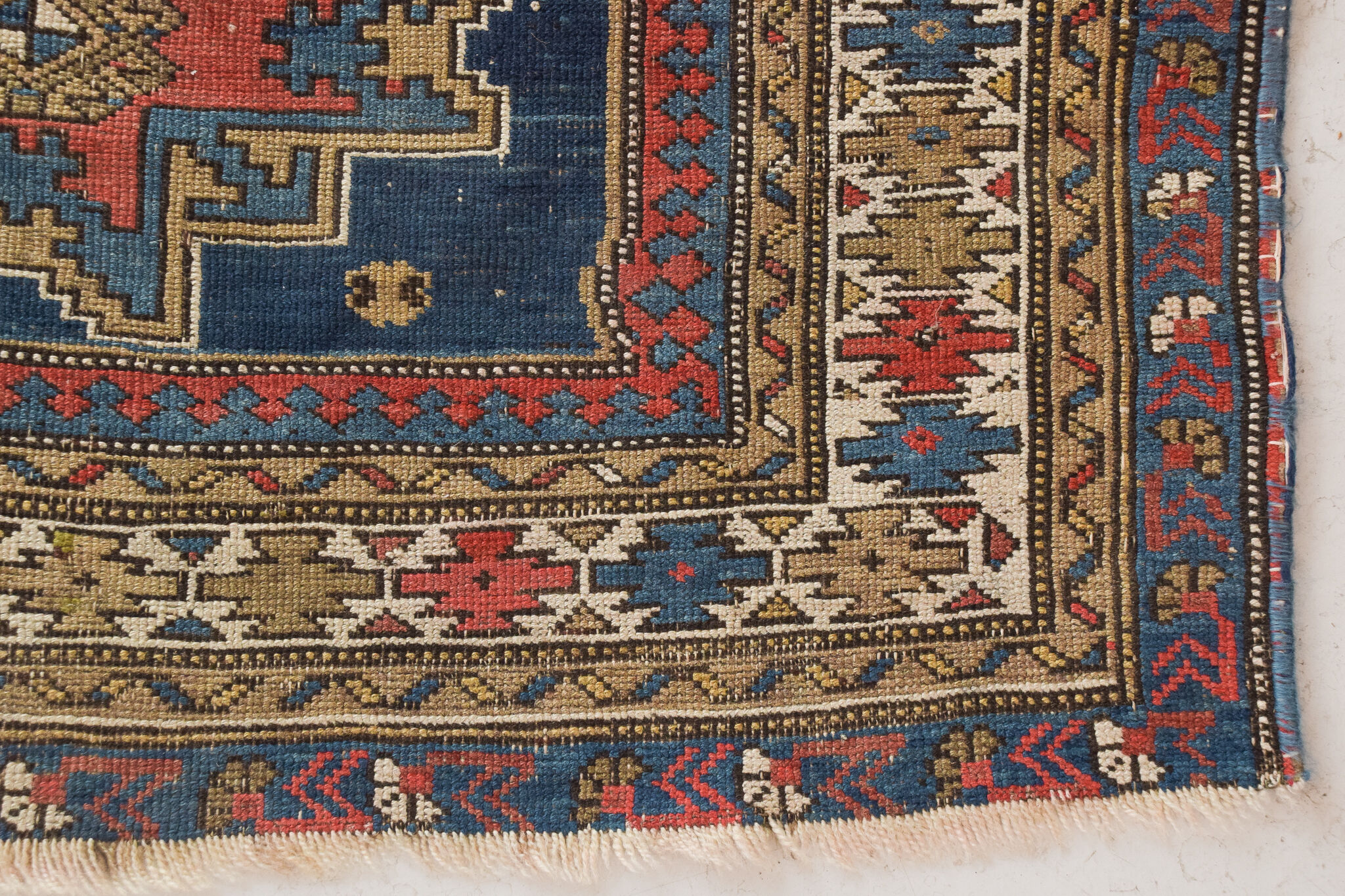 Handwoven blue ground persian rug with bird-like figures