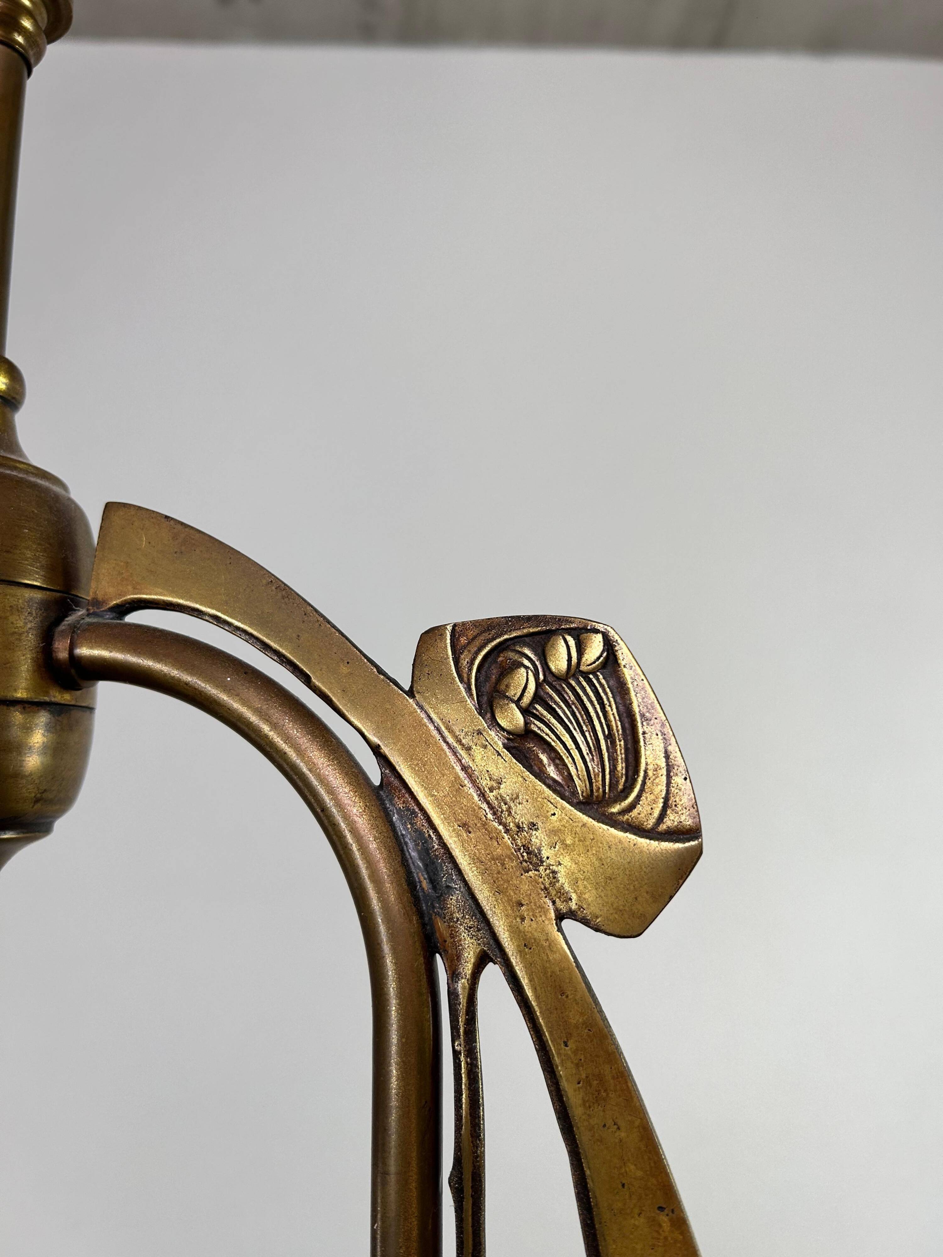 Art Nouveau chandelier with three arms and opalescent iridescent glass.