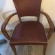 Skai chair binds wine and wooden footpieces and armrests
