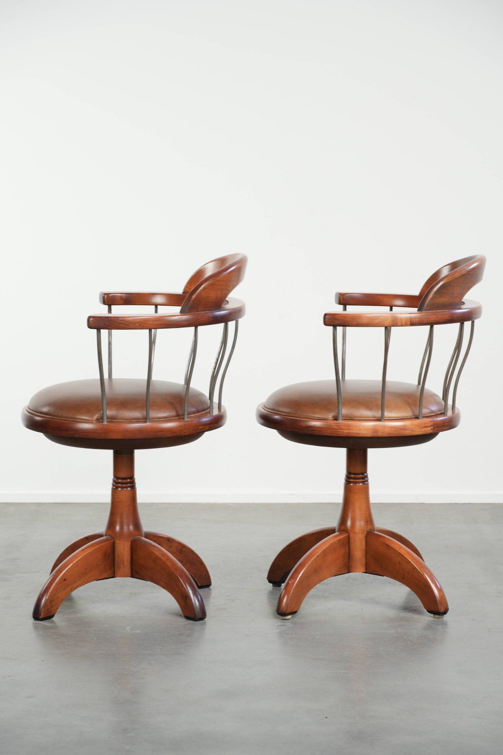 Set of 2 swivel/office chairs with a cognac-coloured cow leather seat