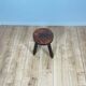 Small brutalist tripod stool in solid wood.