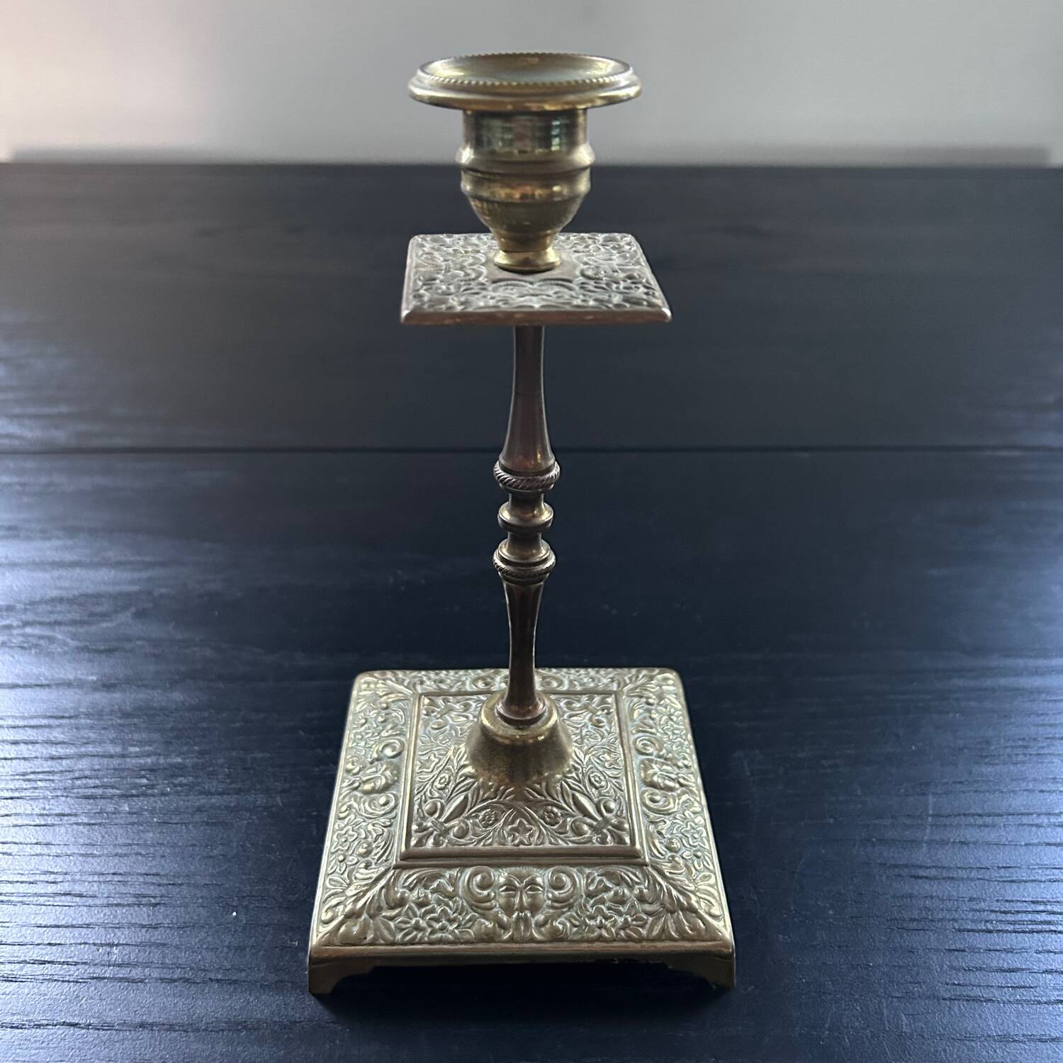 Chiseled brass candle holder