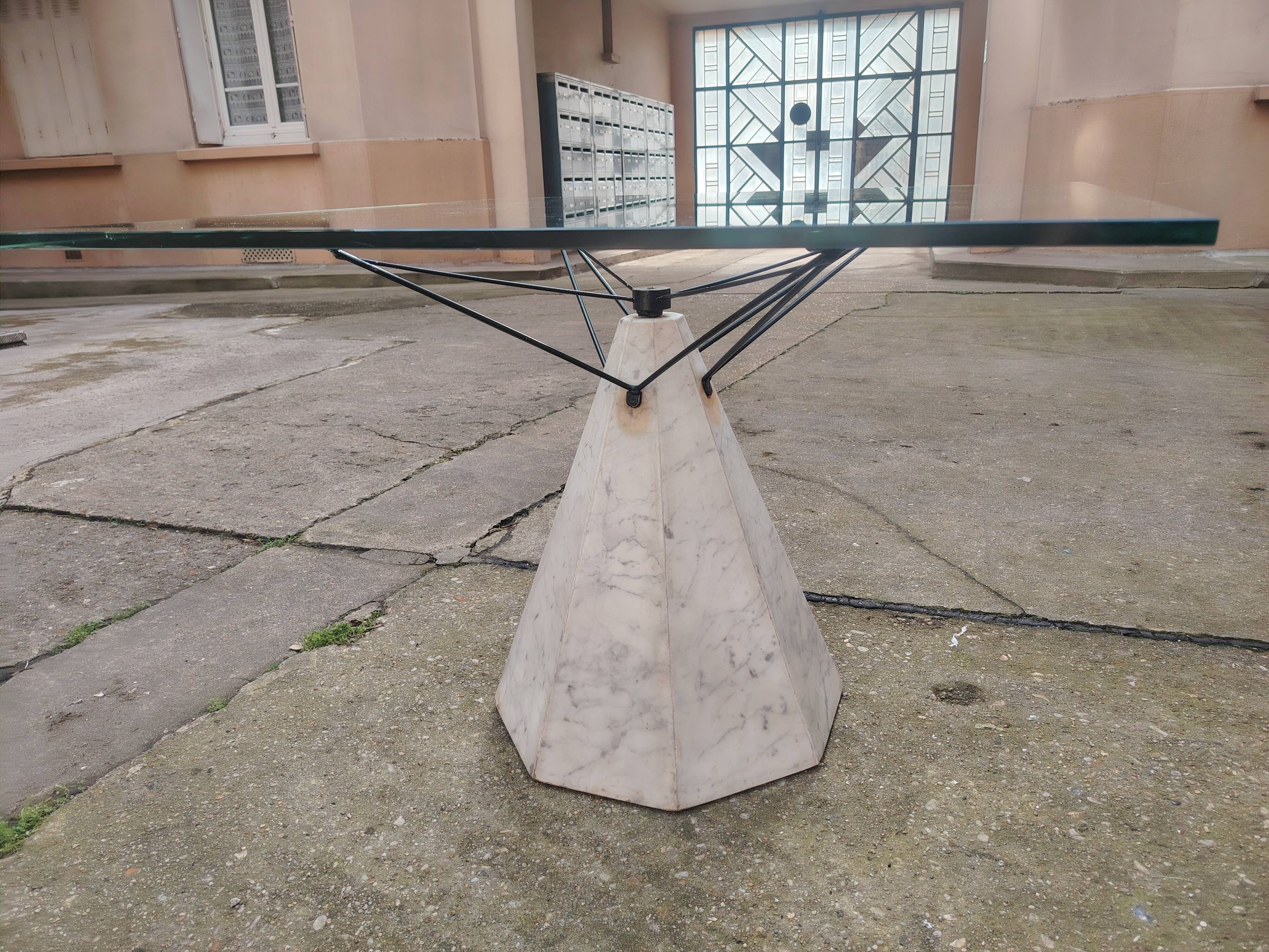 1980s table with a marble and steel base and a square glass top.