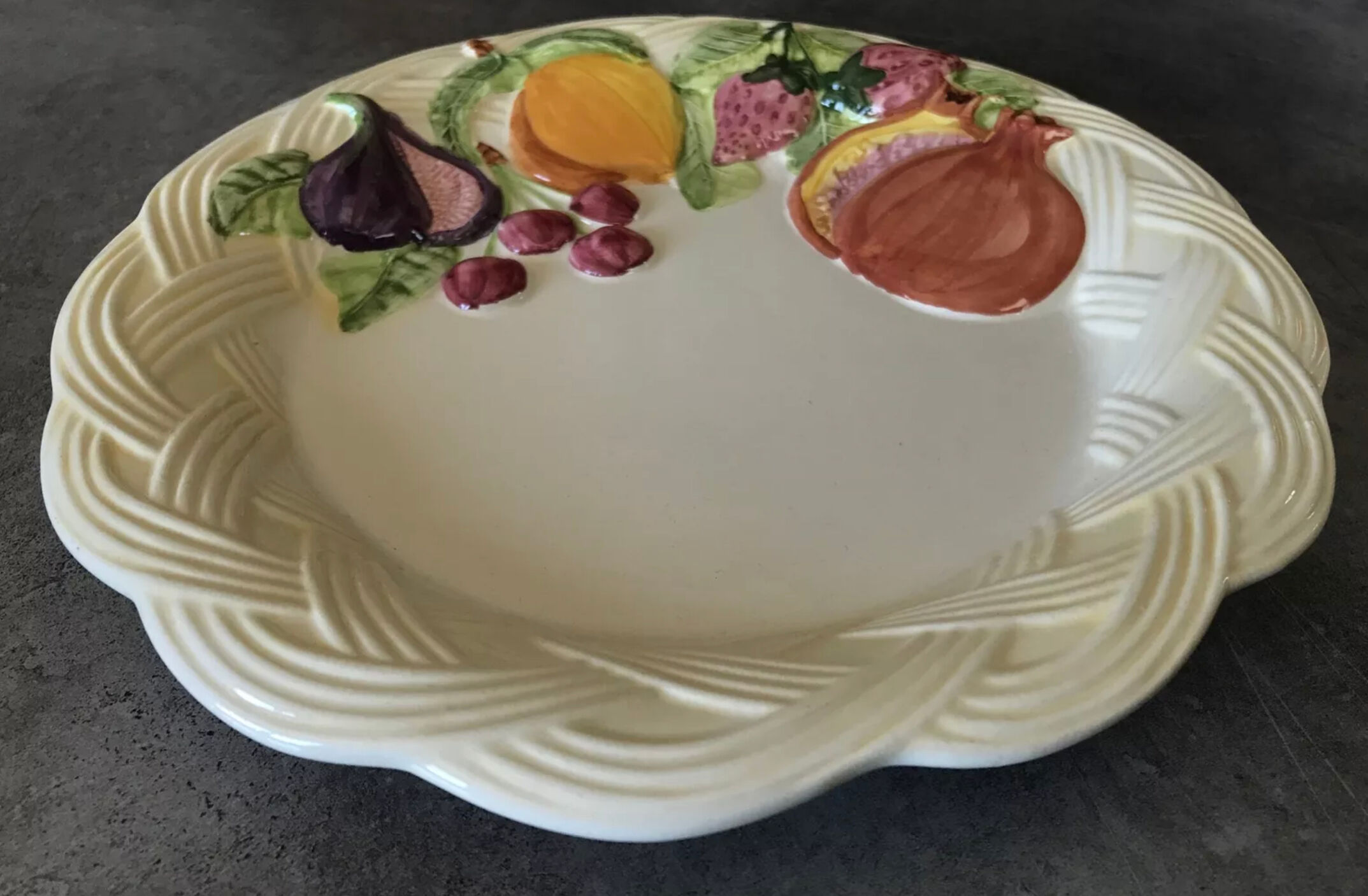Vintage plate in ceramic enamelled decoration of fruits in relief