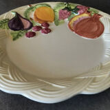 Vintage plate in ceramic enamelled decoration of fruits in relief