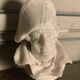 Marble sculpture, man's head in a hat.