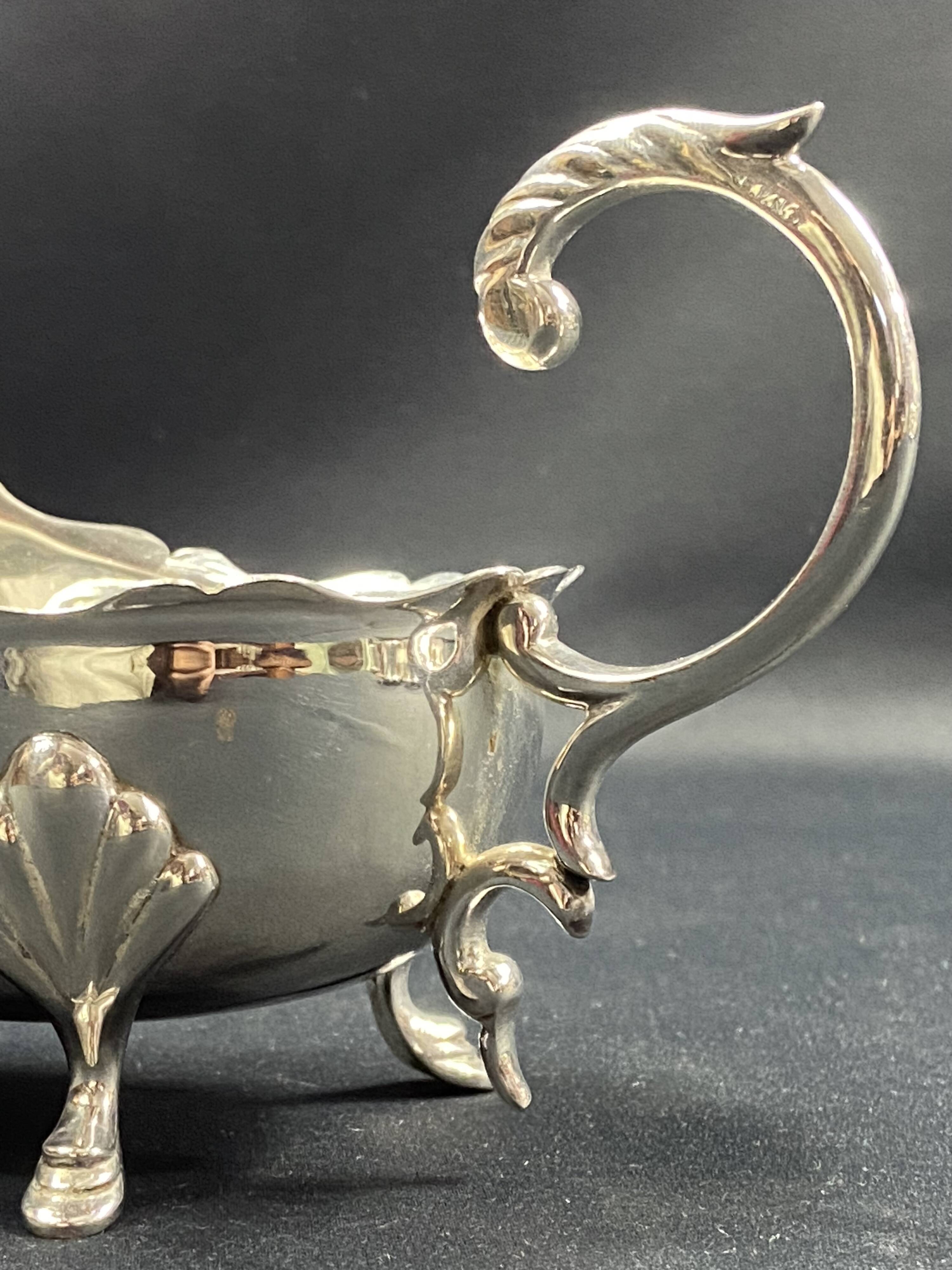English George III style silver plated tripod sauce boat