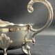 English George III style silver plated tripod sauce boat