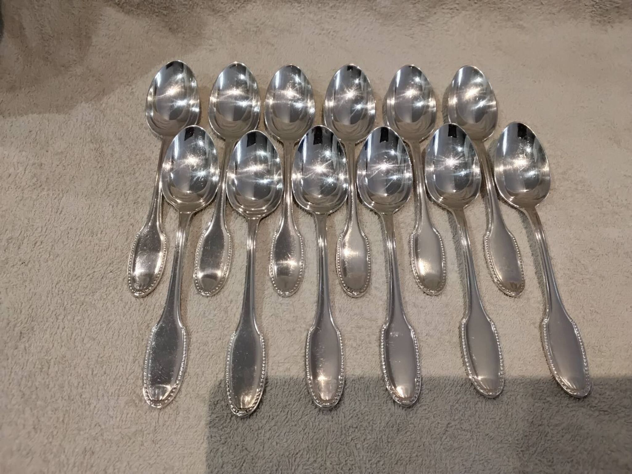 12 silver plated dessert spoons, goldsmith Alfenide, St LXVI pearls
