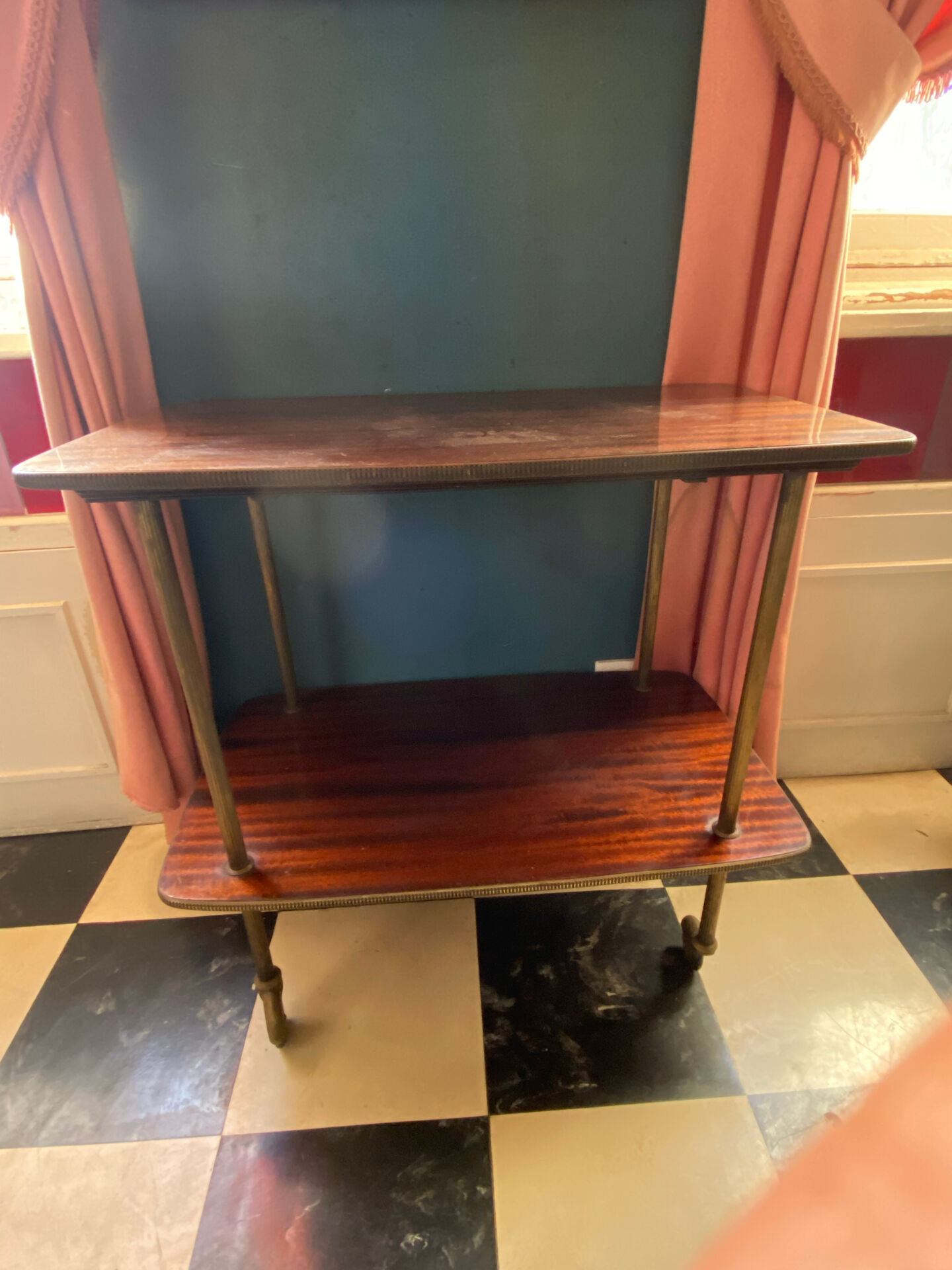 Elegant vintage serving trolley on wheels, two wooden shelves.