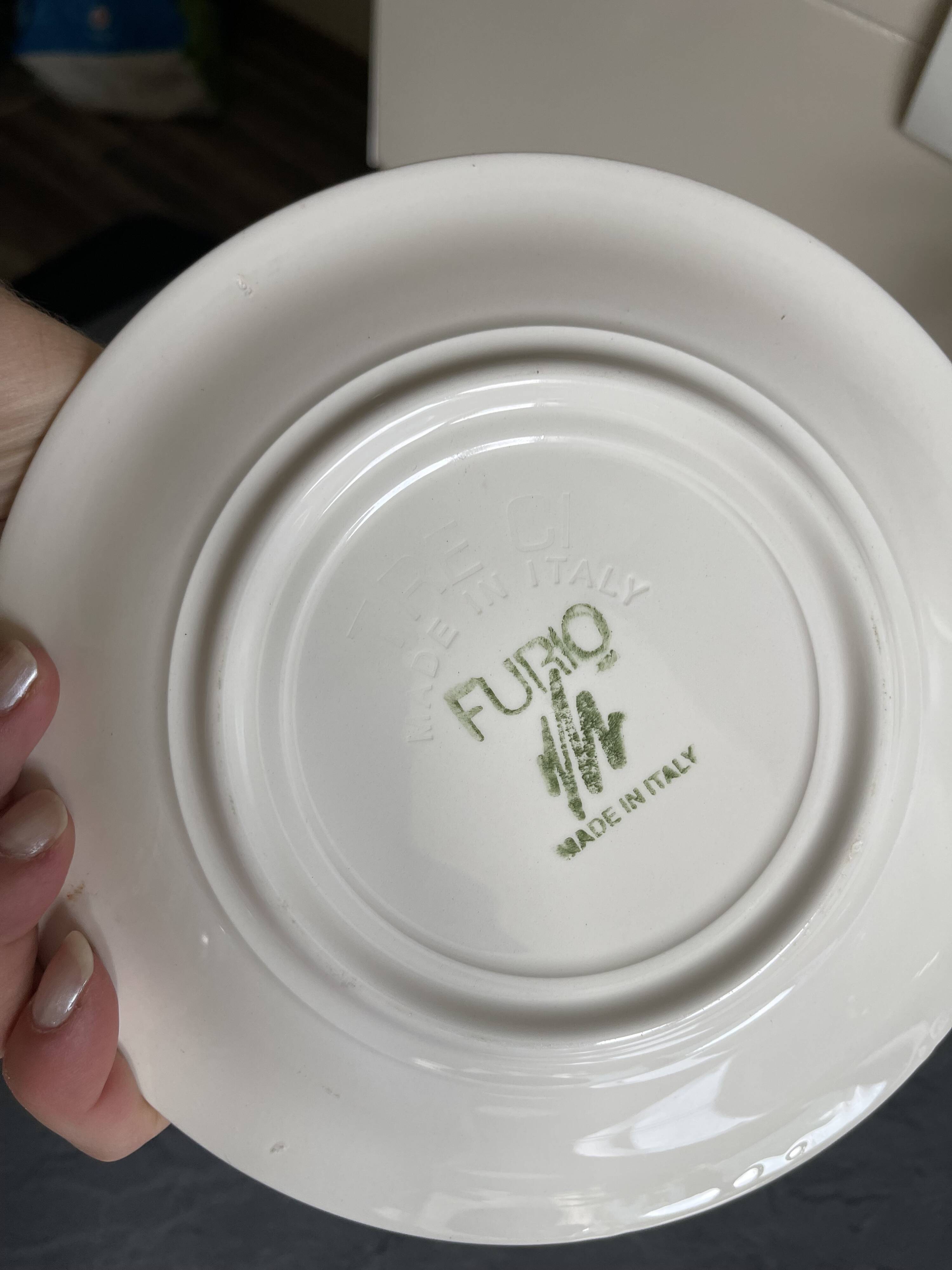 Italian ceramic plates with floral fruit designs.