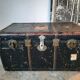Old and large travel trunk, brass-plated corners