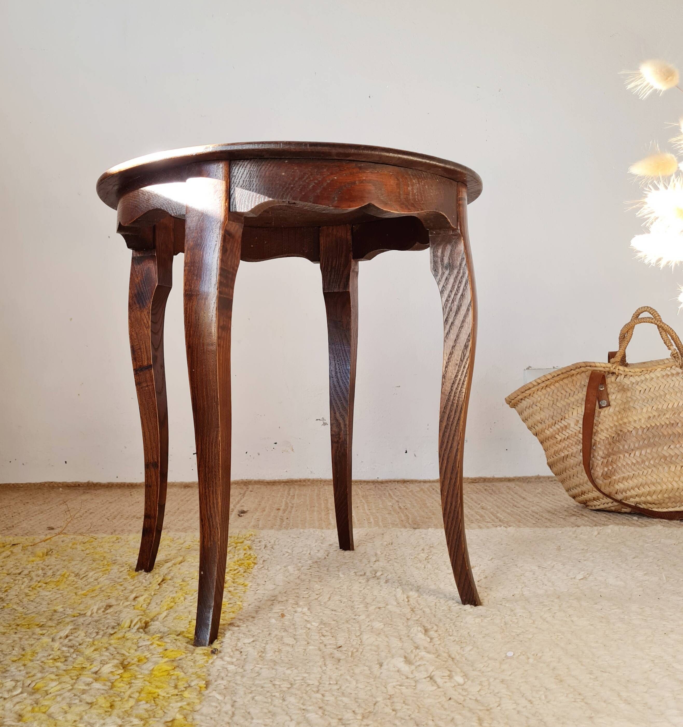 Vintage solid wood side table with curved legs.