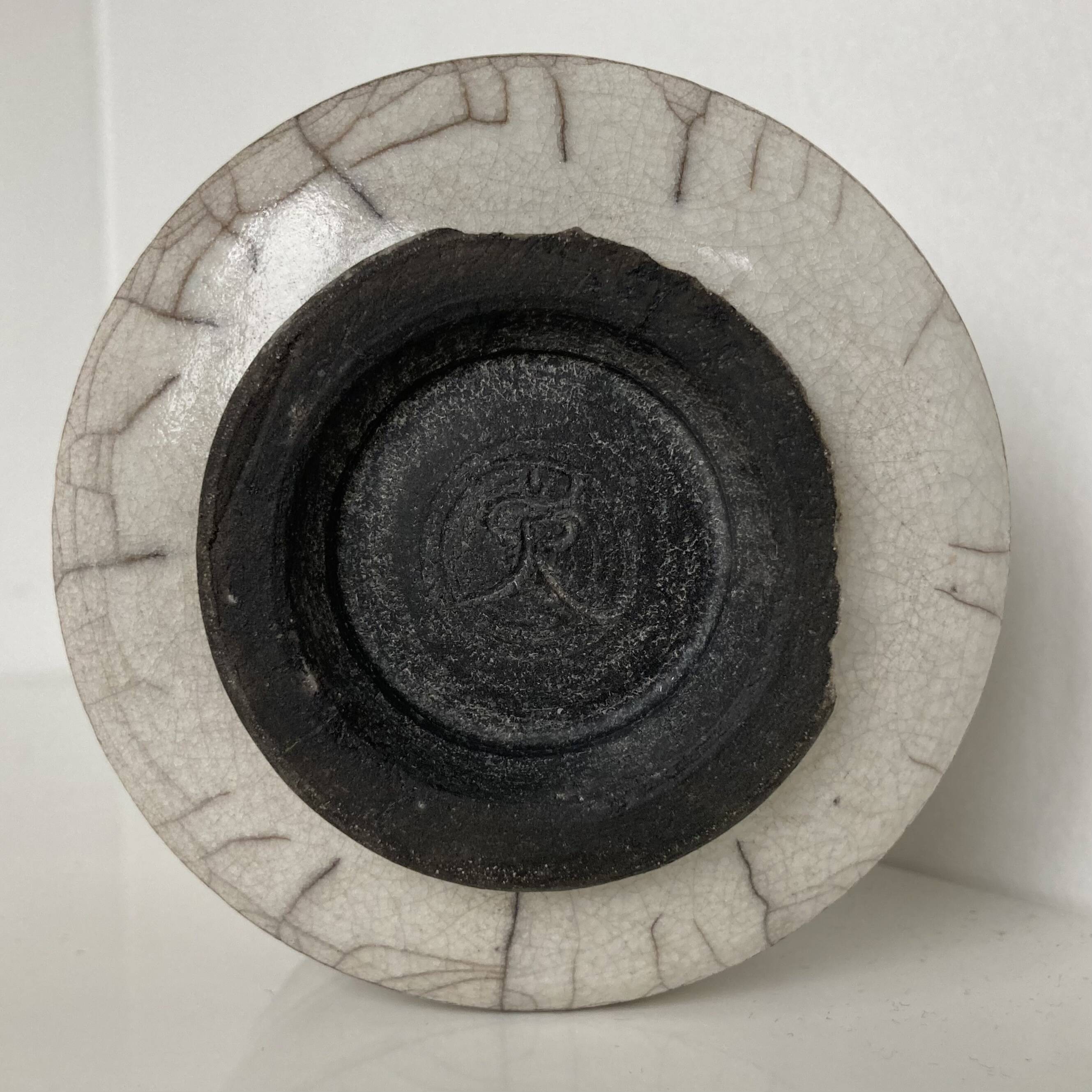 Traditional raku ceramic tea or matcha bowl with mark on the base
