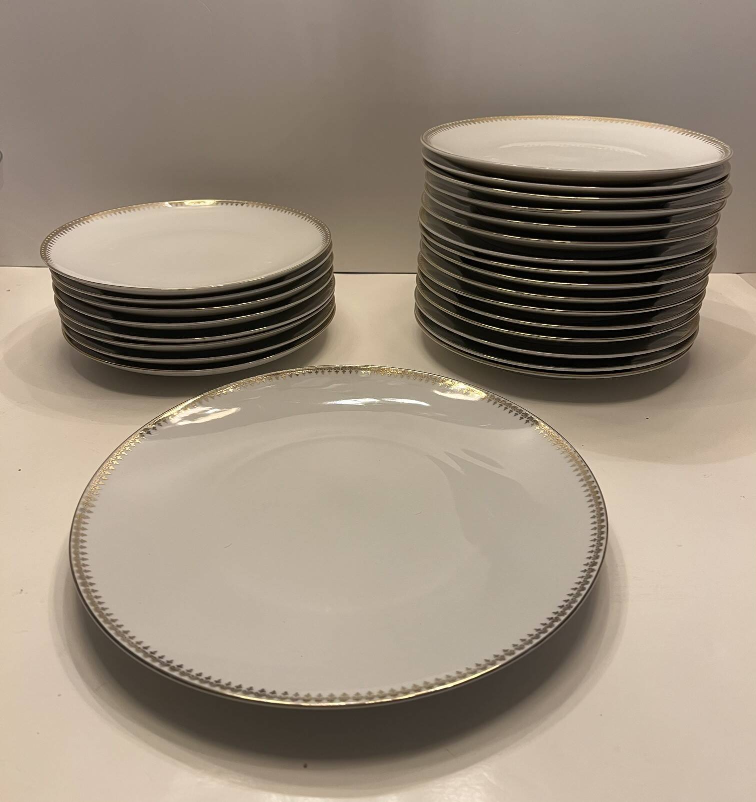 24 plates and a vintage porcelain dish decorated by Lucien Engel.
