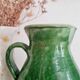 Antique green pitcher in painted terracotta