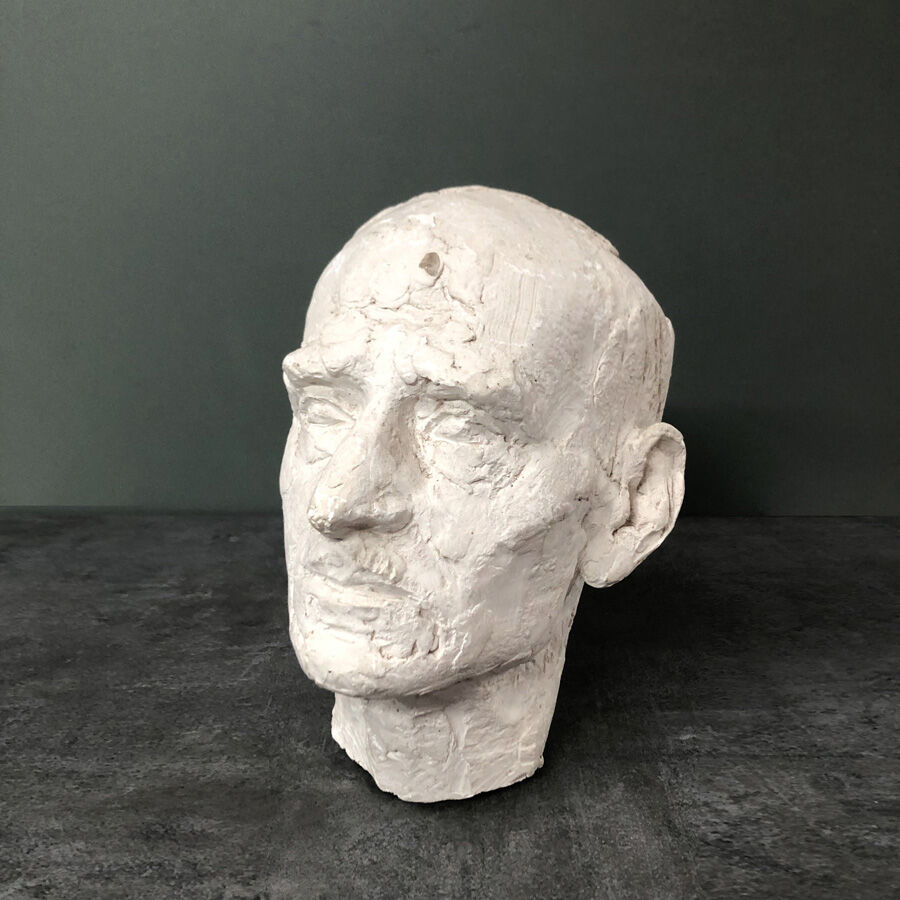Head of a man with a plaster mustache