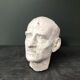 Head of a man with a plaster mustache